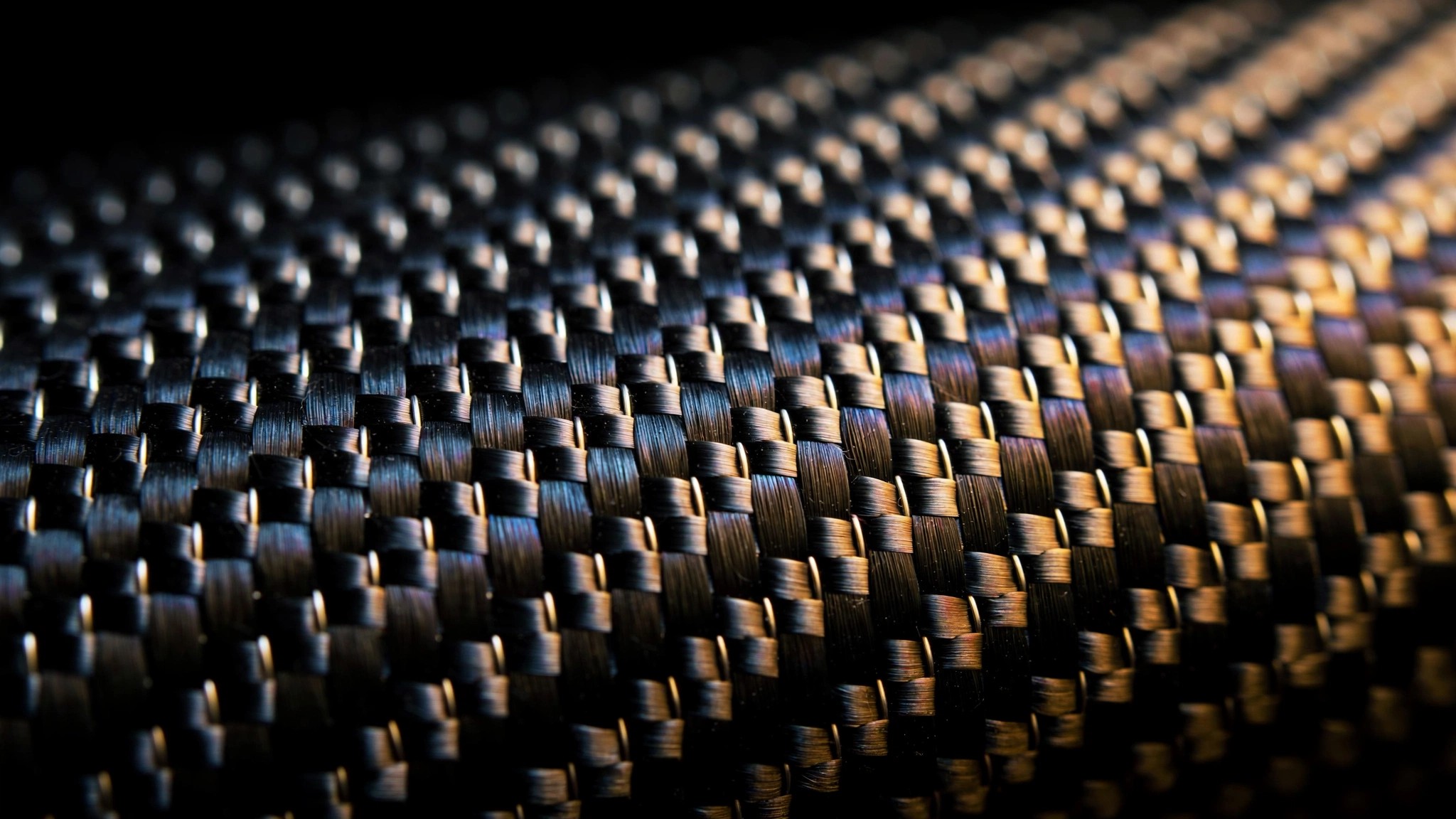 Close-up of Pagani carbo-titanium composite weave showing carbon fiber and titanium filaments